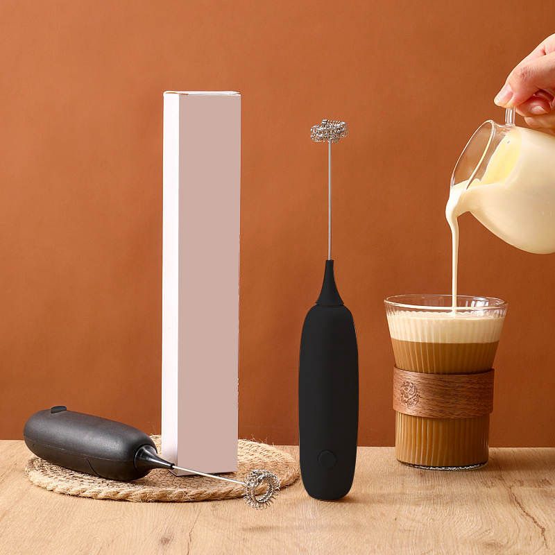 Antioxi Electric Whisk placed next to a white box, highlighting its sleek design and compact size.